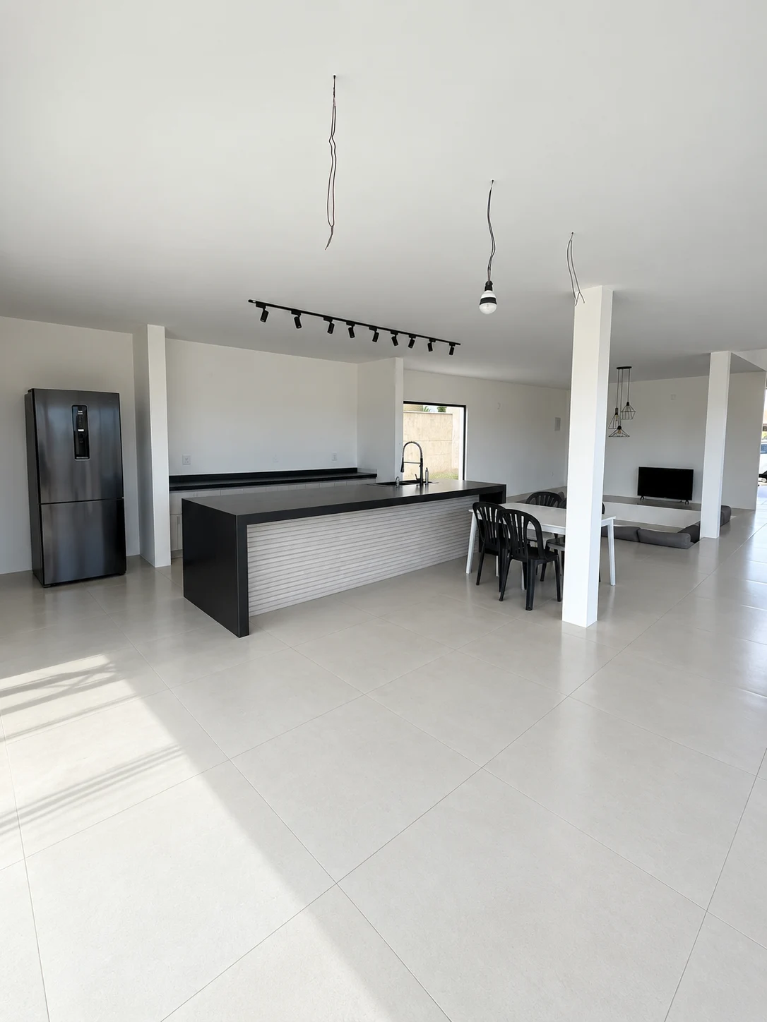 Cozinha aberta com ilha e espaço de refeições